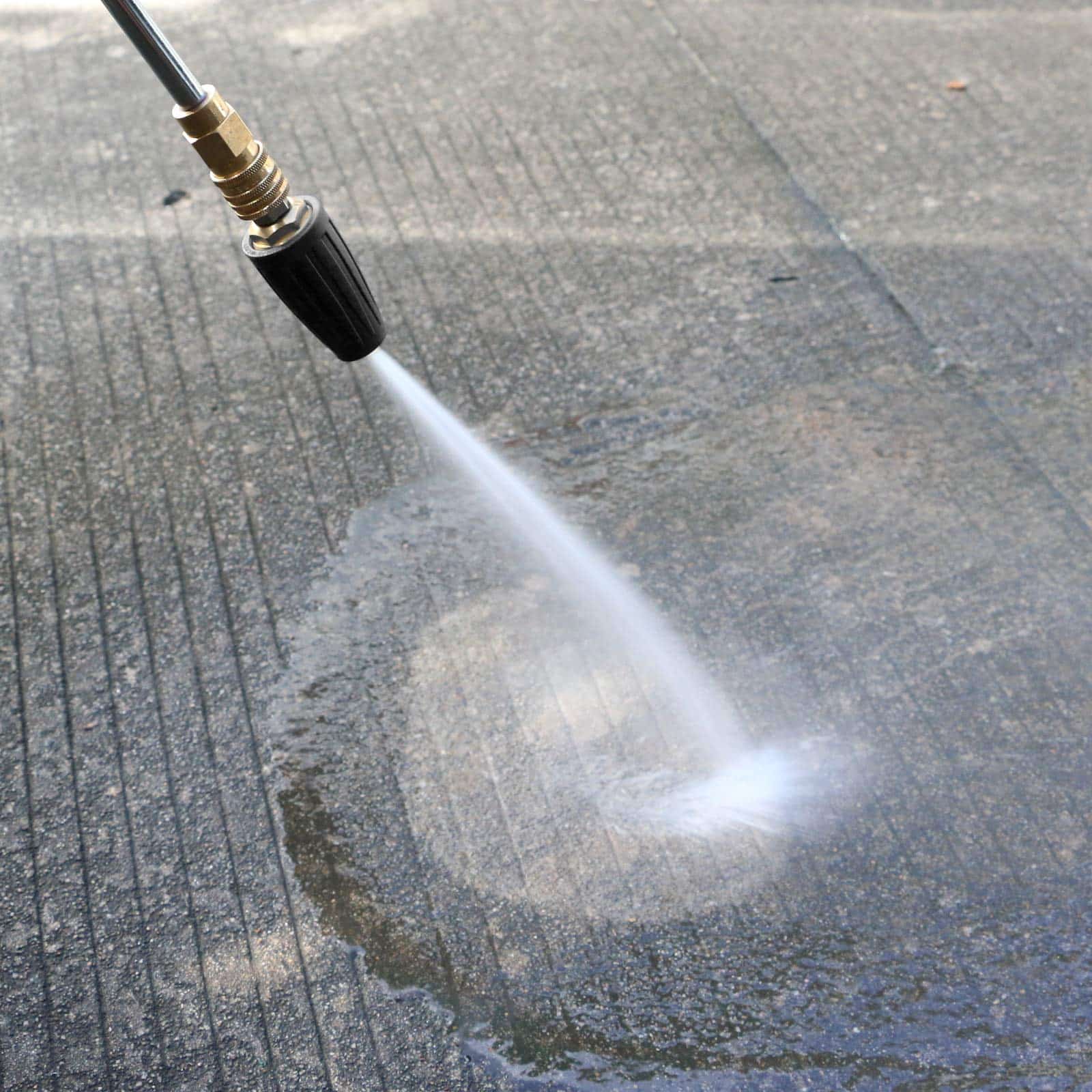 Hose pressure washes pavement